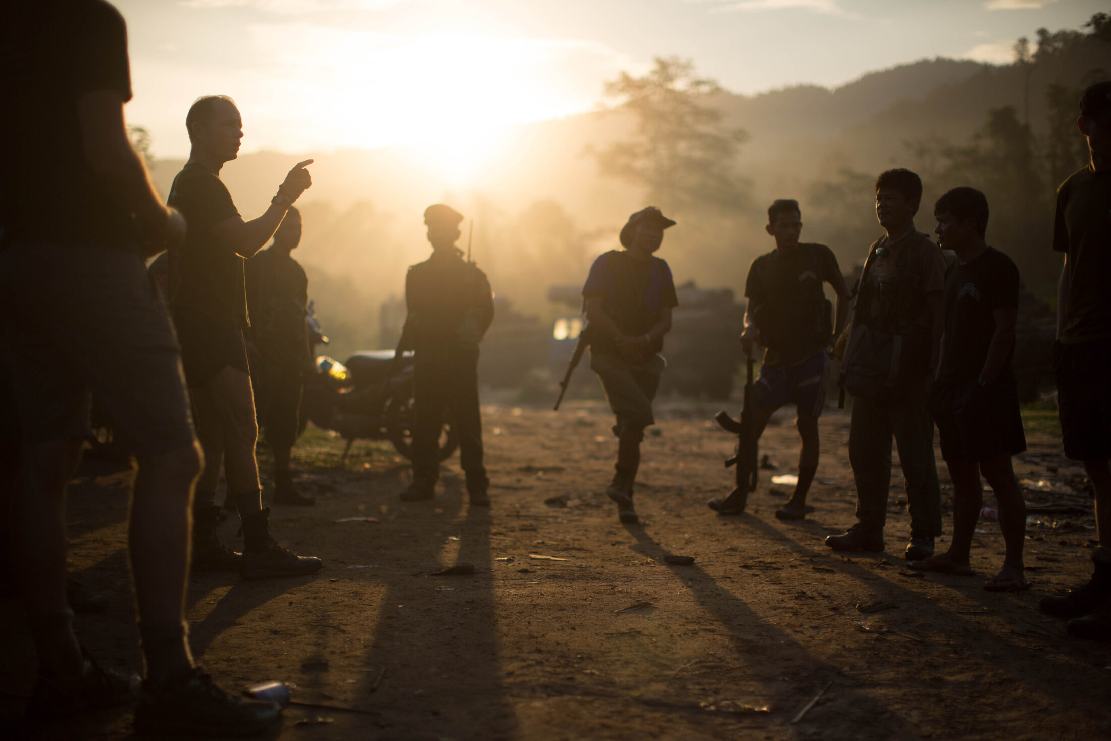 Free Burma Rangers silhouetted against the sunset on the front lines