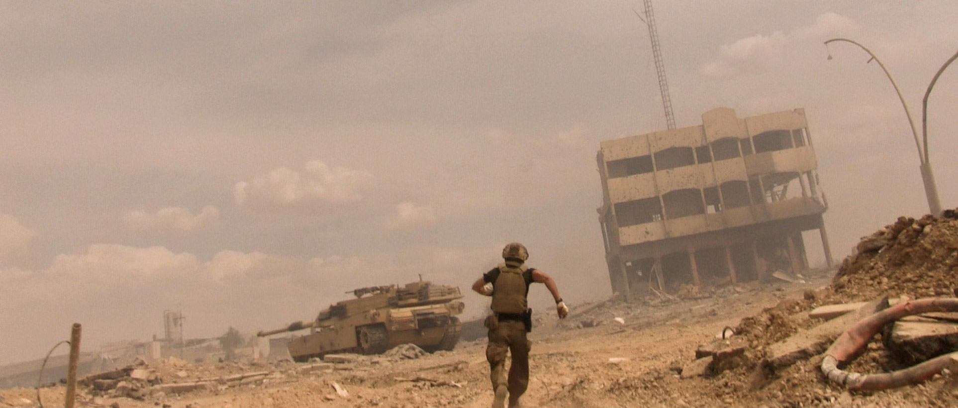 A lone ranger advances toward an armored vehicle